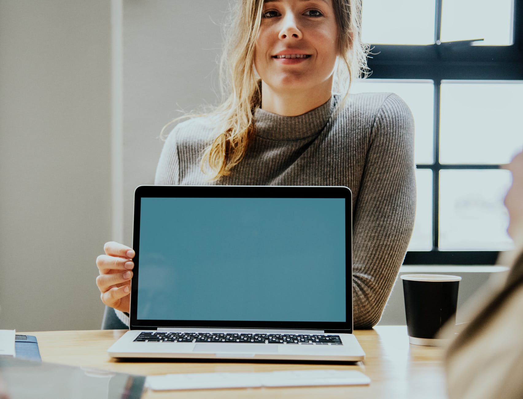 woman holding laptop